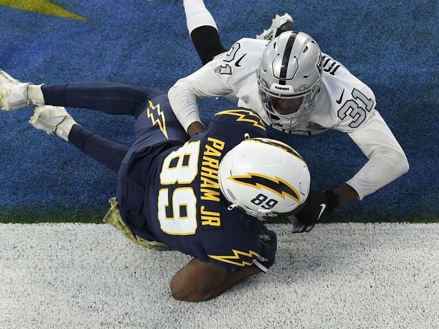 INGLEWOOD, CALIFORNIA - NOVEMBER 08: Donald Parham #89 of the Los Angeles Chargers tries to come down with a fourth quarter touchdown catch next to Isaiah Johnson #31 of the Las Vegas Raiders at SoFi Stadium on November 08, 2020 in Inglewood, California. The play was originally called a touchdown but was overturned on replay to give the Raiders a 31-26 win,