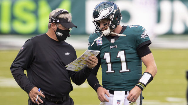 PHILADELPHIA, PA - OCTOBER 18: Head coach Doug Pederson of the Philadelphia Eagles talks to Carson Wentz #11 against the Baltimore Ravens at Lincoln Financial Field on October 18, 2020 in Philadelphia, Pennsylvania.