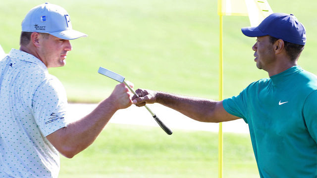 AUGUSTA, GEORGIA - NOVEMBER 09: Bryson DeChambeau of the United States and Tiger Woods of the United States bump fists on the 18th green during a practice round prior to the Masters at Augusta National Golf Club on November 09, 2020 in Augusta, Georgia.