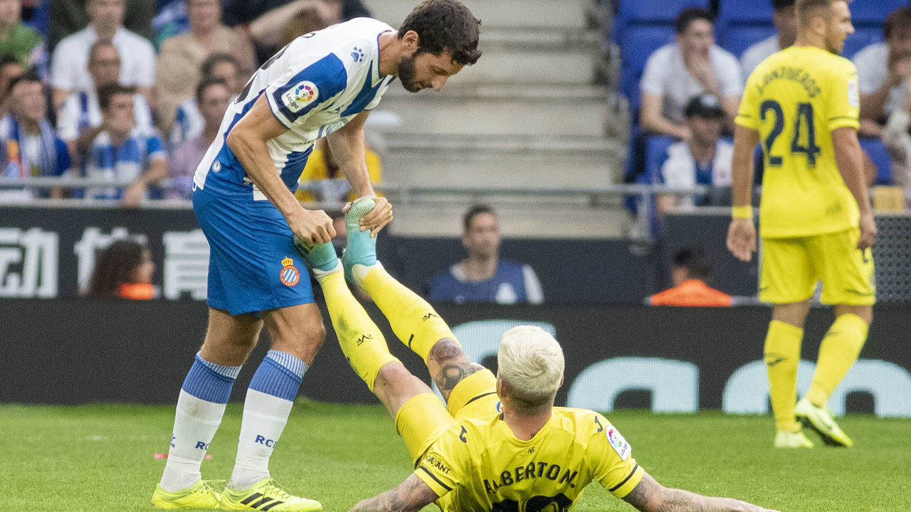 BARCELONA, SPAIN - October 20: Esteban Granero #23 of Espanyol helps Alberto Moreno #18 of Villarreal with cramp during the Espanyol V Villarreal, La Liga regular season match at RCDE Stadium on October 20th 2019 in Barcelona, Spain.