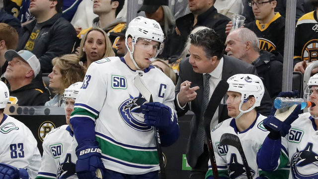 BOSTON, MA - FEBRUARY 04: Vancouver Canucks head coach Travis Green instructs Vancouver Canucks center Bo Horvat (53) during a game between the Boston Bruins and the Vancouver Canucks on February 4, 2020, at TD Garden in Boston, Massachusetts.
