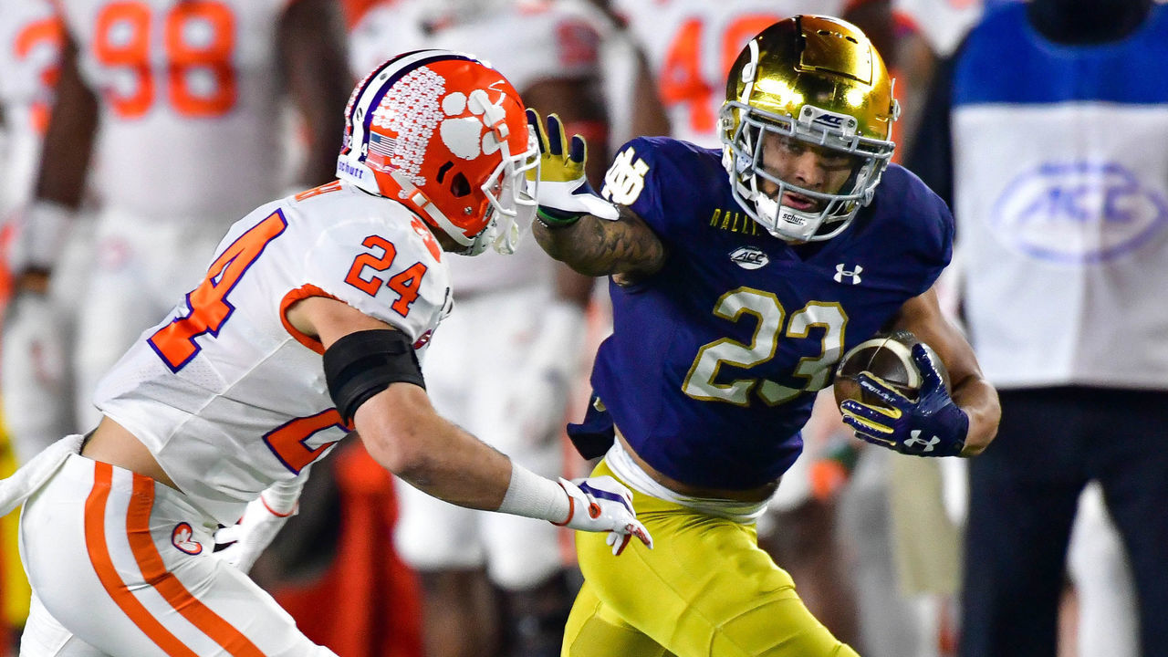 SOUTH BEND, INDIANA - NOVEMBER 07: Running back Kyren Williams #23 of the Notre Dame Fighting Irish stiff arms safety Nolan Turner #24 of the Clemson Tigers on his way to a touchdown in the first quarter at Notre Dame Stadium on November 7, 2020 in South Bend, Indiana.