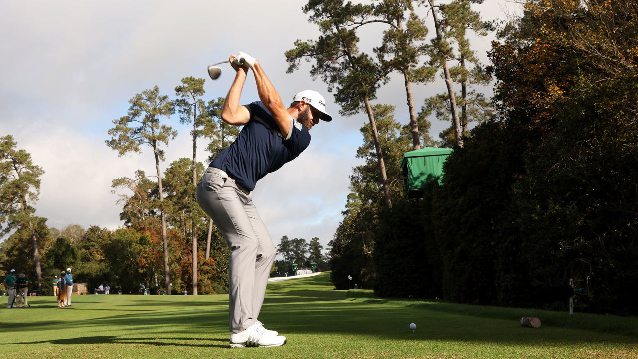 AUGUSTA, GEORGIA - NOVEMBER 13: Dustin Johnson of the United States plays his shot from the 18th tee during the continuation of the first round of the Masters at Augusta National Golf Club on November 13, 2020 in Augusta, Georgia.
