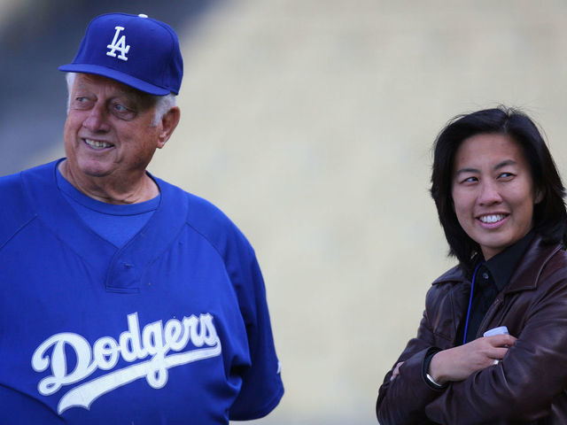 Former Dodgers Manager Tommy Lasorda talks with Assistant General Manager Kim Ng of the Los Angeles Dodgers, before game against the Boston Red Sox at Dodger Stadium in Los Angeles, CA.