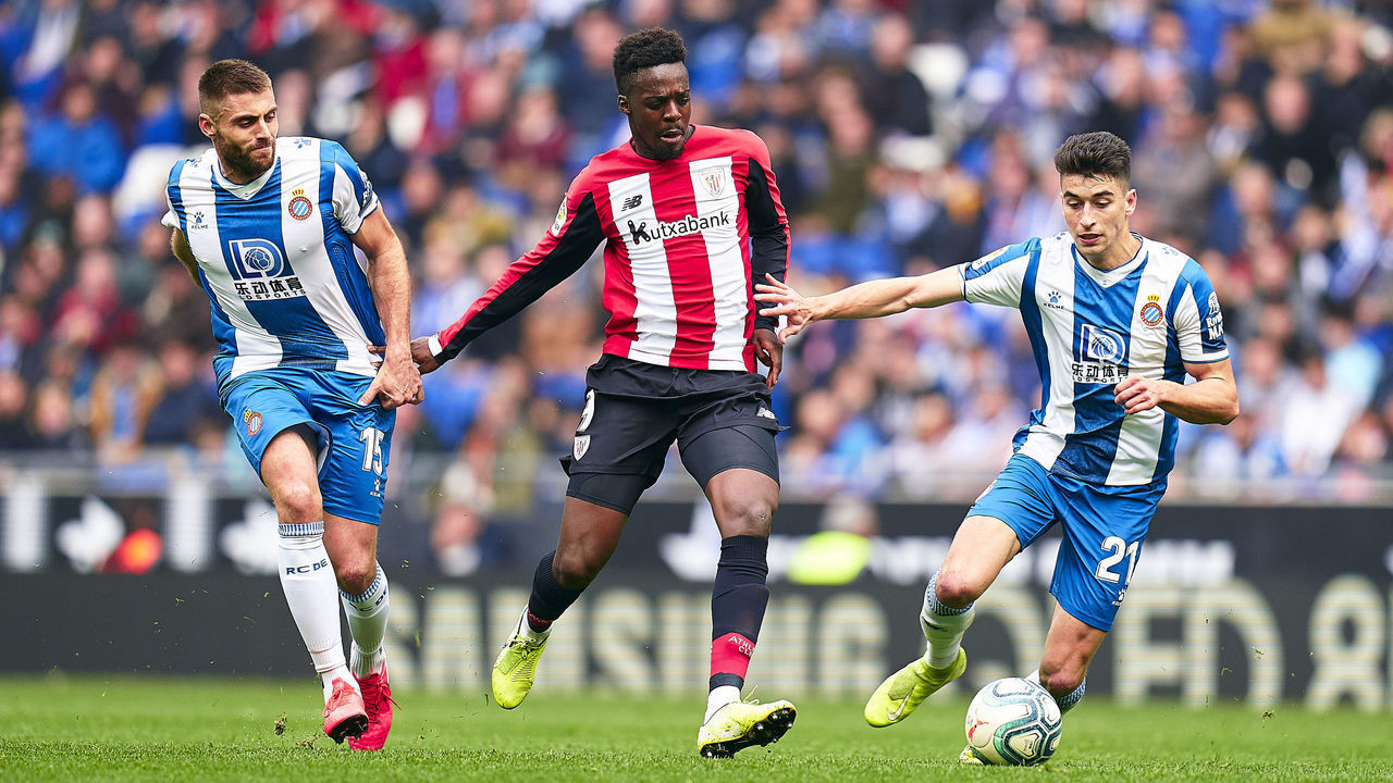 BARCELONA, SPAIN - JANUARY 25: David Lopez and Marc Roca of RCD Espanyol competes for the ball with Inaki Williams of Athletic Club during the Liga match between RCD Espanyol and Athletic Club at RCDE Stadium on January 25, 2020 in Barcelona, Spain.