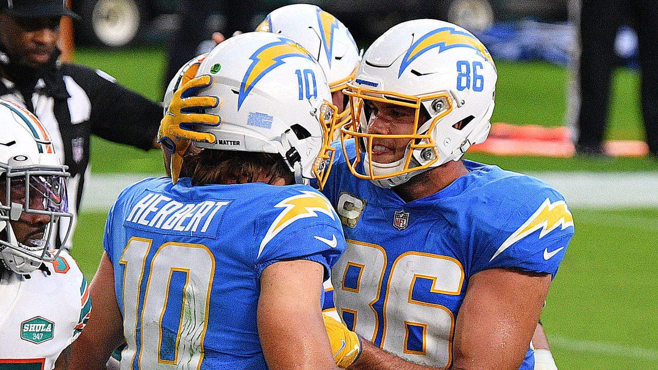MIAMI GARDENS, FLORIDA - NOVEMBER 15: Justin Herbert #10 of the Los Angeles Chargers is congratulated by his teammate Hunter Henry #86 after scoring a rushing touchdown against the Miami Dolphins during the first half at Hard Rock Stadium on November 15, 2020 in Miami Gardens, Florida.
