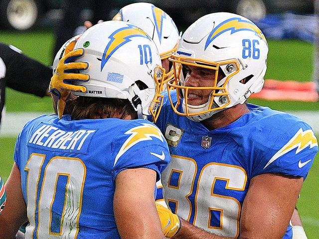 MIAMI GARDENS, FLORIDA - NOVEMBER 15: Justin Herbert #10 of the Los Angeles Chargers is congratulated by his teammate Hunter Henry #86 after scoring a rushing touchdown against the Miami Dolphins during the first half at Hard Rock Stadium on November 15, 2020 in Miami Gardens, Florida.