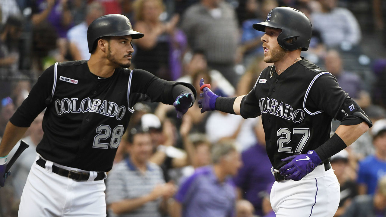 DENVER, CO - AUGUST 02: Colorado Rockies third baseman Nolan Arenado (28) greets shortstop Trevor Story (27) in the batters circle after Story hit a solo home run off of San Francisco Giants starting pitcher Shaun Anderson (64) in the third inning at Coors Field August 02, 2019.