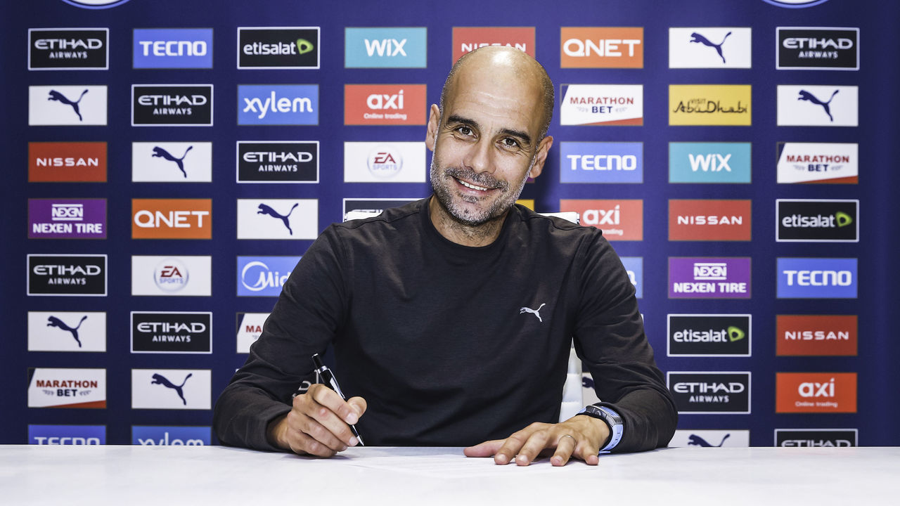 MANCHESTER, ENGLAND - NOVEMBER 19: Pep Guardiola, manager of Manchester City signs a contract extension at Manchester City Football Academy on November 19, 2020 in Manchester, England.