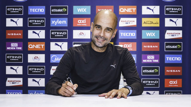 MANCHESTER, ENGLAND - NOVEMBER 19: Pep Guardiola, manager of Manchester City signs a contract extension at Manchester City Football Academy on November 19, 2020 in Manchester, England.