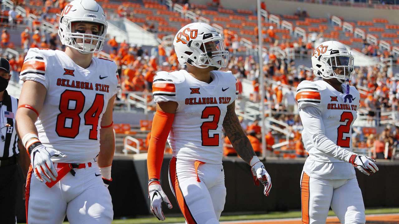 STILLWATER, OK - SEPTEMBER 26: Tight end Dayton Metcalf #84, wide receiver Tylan Wallace #2, and safety Tanner McCalister #2 of the Oklahoma State Cowboys walk onto the field for the coin toss against the West Virginia Mountaineers on September 26, 2020 at Boone Pickens Stadium in Stillwater, Oklahoma. OSU won 27-13.