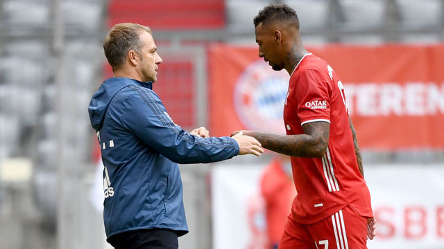Bayern Munich's German head coach Hans-Dieter Flick (L) talks to Bayern Munich's German defender Jerome Boateng after the German first division Bundesliga football match FC Bayern Munich v SC Freiburg on June 20, 2020 in Munich, southern Germany.