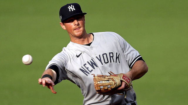 SAN DIEGO, CALIFORNIA - OCTOBER 09: DJ LeMahieu #26 of the New York Yankees throws out the runner against the Tampa Bay Rays during the first inning in Game Five of the American League Division Series at PETCO Park on October 09, 2020 in San Diego, California.