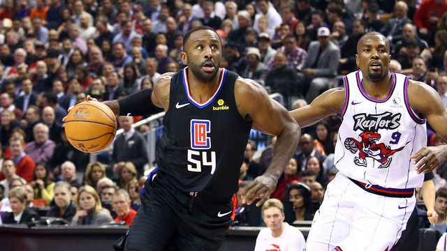 TORONTO, ON - DECEMBER 11: Patrick Patterson #54 of the Los Angeles Clippers dribbles the ball as Serge Ibaka #9 of the Toronto Raptors defends during the first half of an NBA game at Scotiabank Arena on December 11, 2019 in Toronto, Canada.