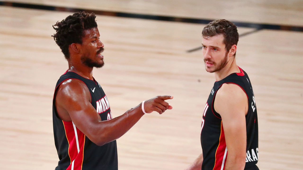 LAKE BUENA VISTA, FLORIDA - AUGUST 22: (L-R) Jimmy Butler #22 and Goran Dragic #7 of the Miami Heat talk during the first half of Game 3 of an NBA basketball first-round playoff series against the Indiana Pacers at AdventHealth Arena on August 22, 2020 in Lake Buena Vista, Florida.