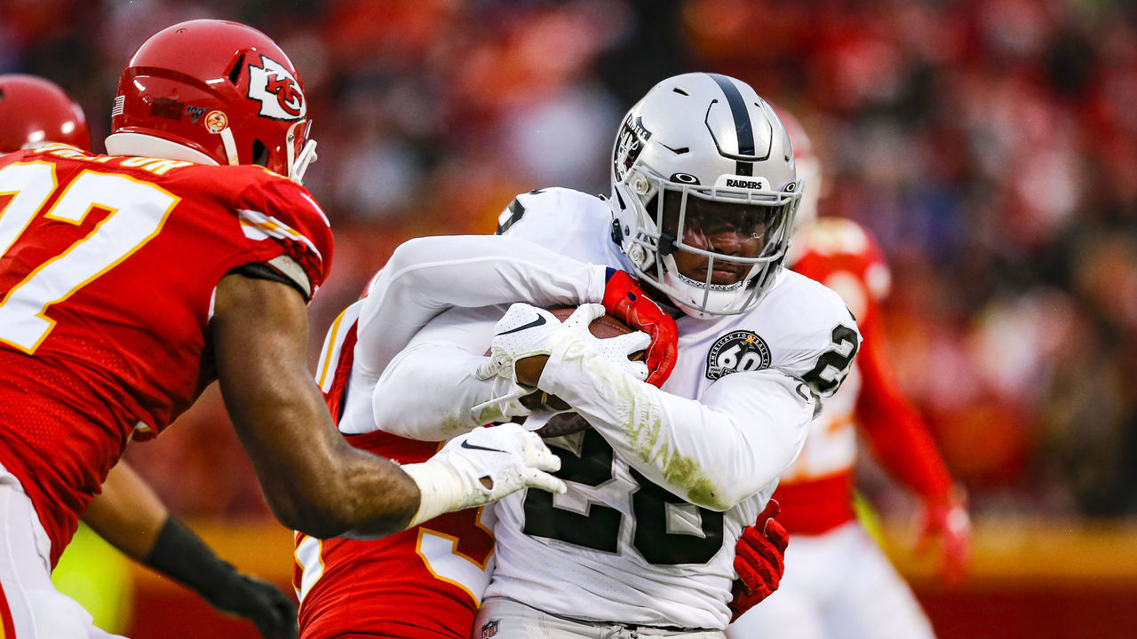 KANSAS CITY, MO - DECEMBER 01: Tyrann Mathieu #32 of the Kansas City Chiefs tackles Josh Jacobs #28 of the Oakland Raiders during a first quarter run at Arrowhead Stadium on December 1, 2019 in Kansas City, Missouri.