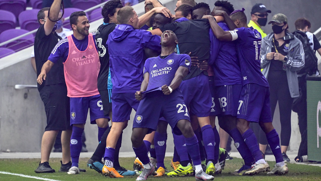 ORLANDO, FLORIDA - NOVEMBER 21: Benji Michel #19 of Orlando City SC celebrates with teammates after scoring the game winning goal kick to defeat the against the New York City FC during Round One of the MLS Cup Playoffs at Exploria Stadium on November 21, 2020 in Orlando, Florida.