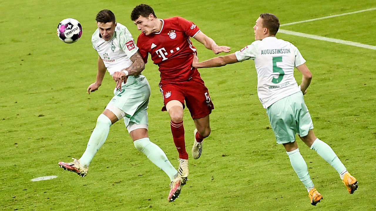 Bayern Munich's French defender Benjamin Pavard (C), Bremen's Austrian forward Marco Friedl (L) and Bremen's Swedish defender Ludwig Augustinsson (R) vie for the ball during the German first division Bundesliga football match Bayern Munich vs Werder Bremen in Munich, on November 21, 2020.