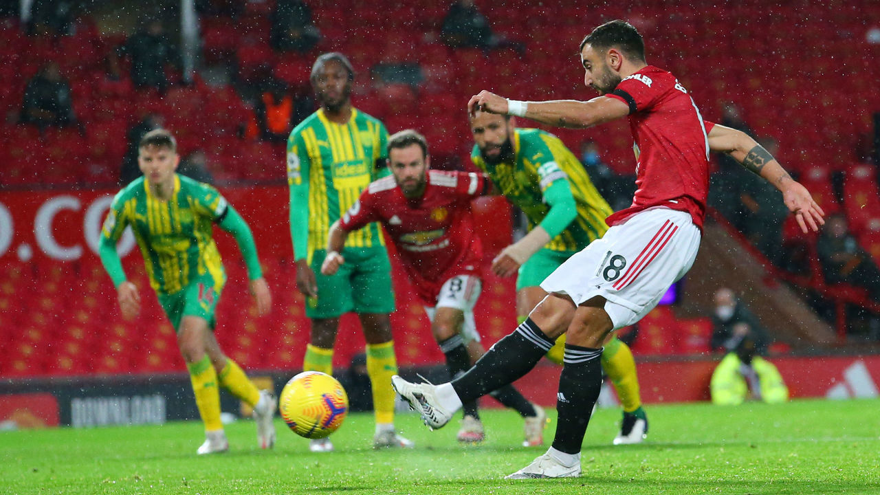 MANCHESTER, ENGLAND - NOVEMBER 21: Bruno Fernandes of Manchester United scores his team's first goal, a penalty which he is retaking following a VAR review that decided Sam Johnstone of West Bromwich Albion (not pictured) was off his line, during the Premier League match between Manchester United and West Bromwich Albion at Old Trafford on November 21, 2020 in Manchester, England. Sporting stadiums around the UK remain under strict restrictions due to the Coronavirus Pandemic as Government social distancing laws prohibit fans inside venues resulting in games being played behind closed doors.