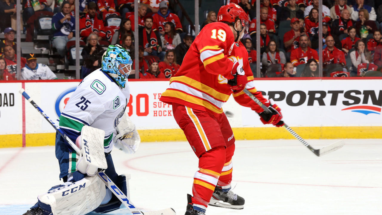 CALGARY, ALBERTA - OCTOBER 05: Matthew Tkachuk #19 of the Calgary Flames skates against Jacob Markstrom #25 of the Vancouver Canucks at Scotiabank Saddledome on October 05, 2019 in Calgary, Canada.