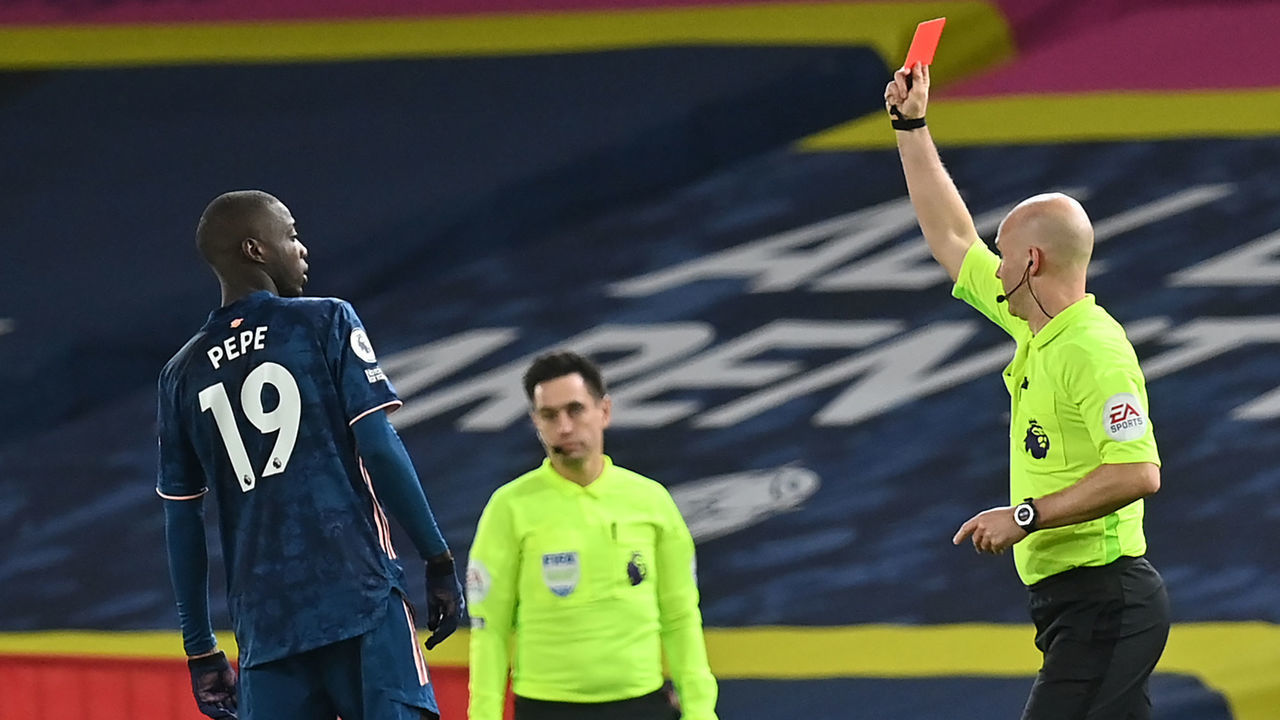 Arsenal's French-born Ivorian midfielder Nicolas Pepe (L) is shown a red card by atch Referee Anthony Taylor (R) during the English Premier League football match between Leeds United and Arsenal at Elland Road in Leeds, northern England on November 22, 2020.