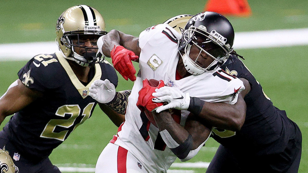 NEW ORLEANS, LOUISIANA - NOVEMBER 22: Julio Jones #11 of the Atlanta Falcons is tackled by Demario Davis #56,Marcus Williams #43 and Patrick Robinson #21 of the New Orleans Saints in the first quarter at Mercedes-Benz Superdome on November 22, 2020 in New Orleans, Louisiana.