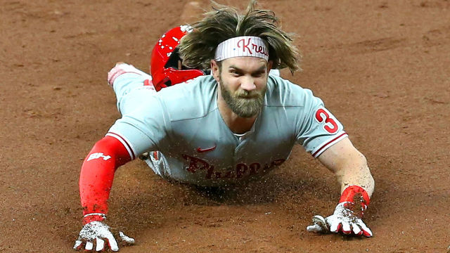 ST. PETERSBURG, FL - SEPTEMBER 25: Bryce Harper (3) of the Phillies dives safely into third base with a triple during the game between the Philadelphia Phillies and Tampa Bay Rays on September 25, 2020 at Tropicana Field in St. Petersburg, FL.