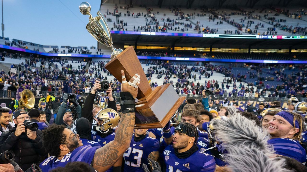 SEATTLE, WA - NOVEMBER 29: The Washington Huskies including center Nick Henry (56) hold up the Apple Cup trophy after winning the 112th Apple Cup between the Washington Huskies and the Washington State Cougars on Friday, November 29, 2019 at Husky Stadium in Seattle, WA.