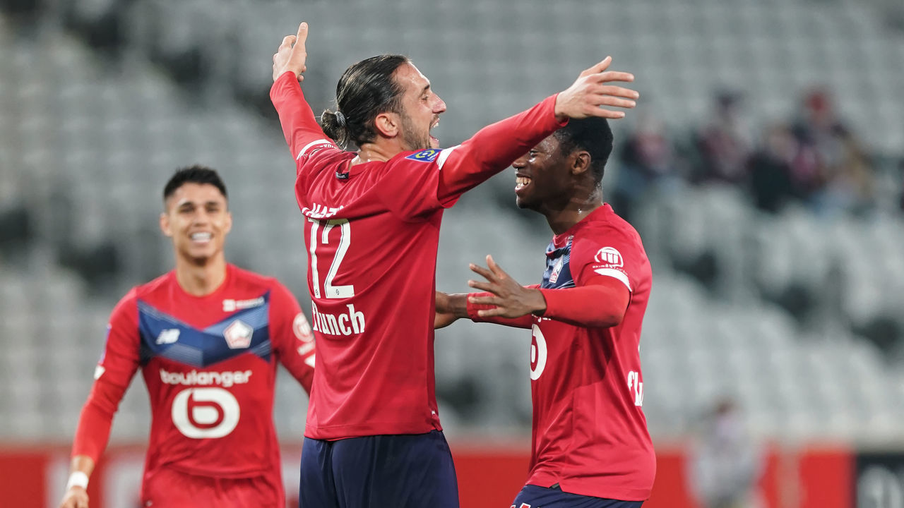LILLE, FRANCE - NOVEMBER 22: Yusuf Yazici (C) of Lille OSC celebrates with team mate Jonathan David of Lille OSC after scoring his teams first goal during the Ligue 1 Uber Eats match between Lille OSC and FC Lorient at Stade Pierre Mauroy on November 22, 2020 in Lille, France.
