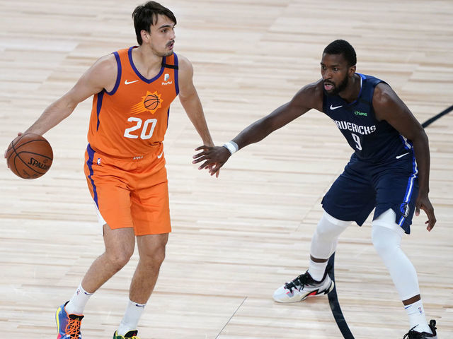 LAKE BUENA VISTA, FLORIDA - AUGUST 13: Dario Saric #20 of the Phoenix Suns brings the ball up court against Michael Kidd-Gilchrist #9 of the Dallas Mavericks in the second half at AdventHealth Arena at ESPN Wide World Of Sports Complex on August 13, 2020 in Lake Buena Vista, Florida.