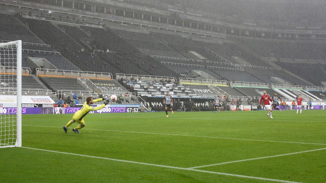 NEWCASTLE UPON TYNE, ENGLAND - OCTOBER 17: Man Utd goalkeeper David de Gea makes a save inside an empty stadium during the Premier League match between Newcastle United and Manchester United at St. James Park on October 17, 2020 in Newcastle upon Tyne, United Kingdom. Sporting stadiums around the UK remain under strict restrictions due to the Coronavirus Pandemic as Government social distancing laws prohibit fans inside venues resulting in games being played behind closed doors.