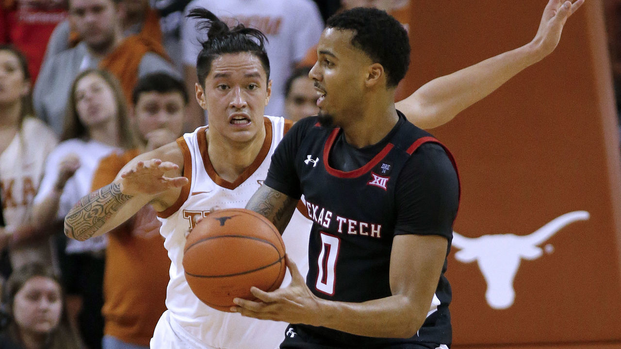 AUSTIN, TEXAS - FEBRUARY 08: Kamaka Hepa #33 of the Texas Longhorns defends Kyler Edwards #0 of the Texas Tech Red Raiders at The Frank Erwin Center on February 08, 2020 in Austin, Texas.