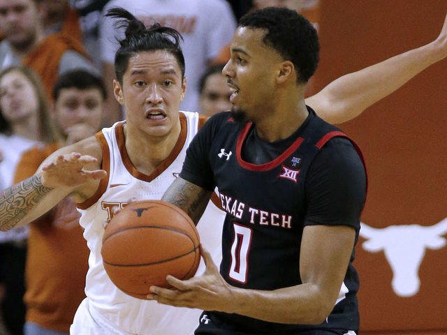 AUSTIN, TEXAS - FEBRUARY 08: Kamaka Hepa #33 of the Texas Longhorns defends Kyler Edwards #0 of the Texas Tech Red Raiders at The Frank Erwin Center on February 08, 2020 in Austin, Texas.
