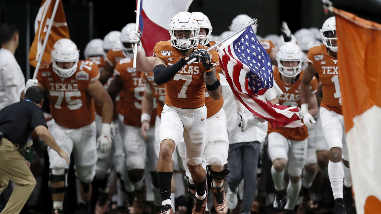 SAN ANTONIO, TX - DECEMBER 31: Caden Sterns #7 of the Texas Longhorns leads the team on to the field during the Valero Alamo Bowl against the Utah Utes at the Alamodome on December 31, 2019 in San Antonio, Texas.