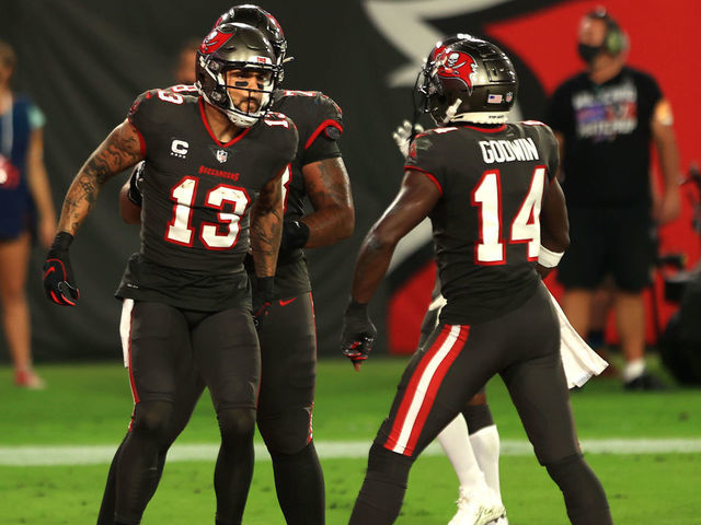 TAMPA, FLORIDA - NOVEMBER 23: Mike Evans #13 of the Tampa Bay Buccaneers celebrates alongside Chris Godwin #14 after scoring a nine-yard touchdown against the Los Angeles Rams during the first quarter in the game at Raymond James Stadium on November 23, 2020 in Tampa, Florida.