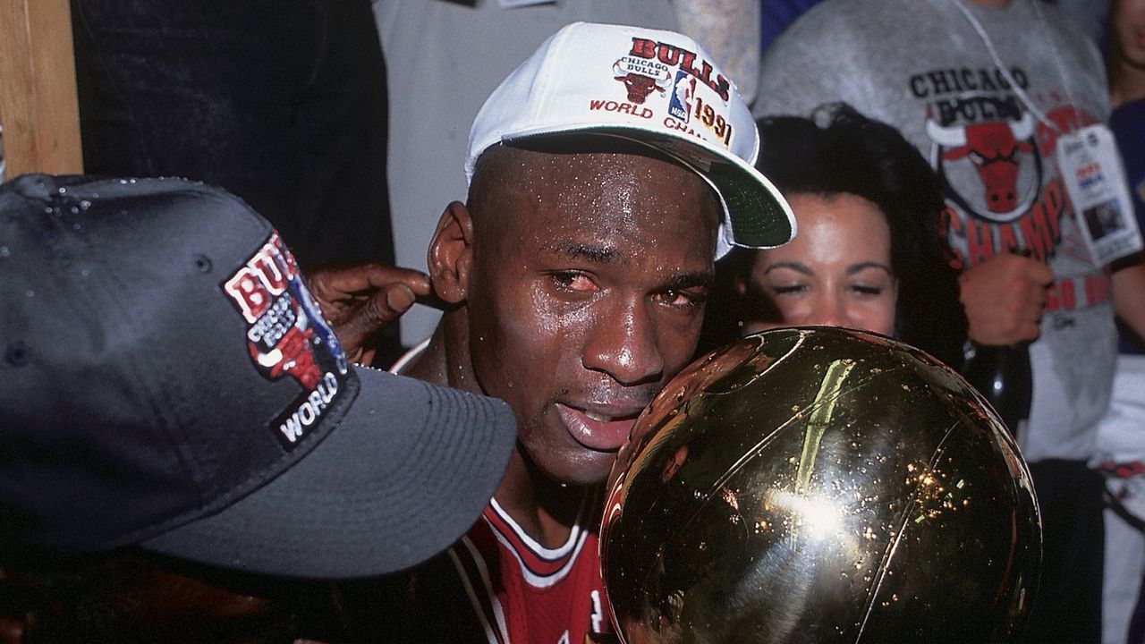 UNITED STATES - JUNE 12: Basketball: finals, Closeup of Chicago Bulls Michael Jordan victorious with wife Juanita and trophy after game vs Los Angeles Lakers, Los Angeles, CA 6/12/1991