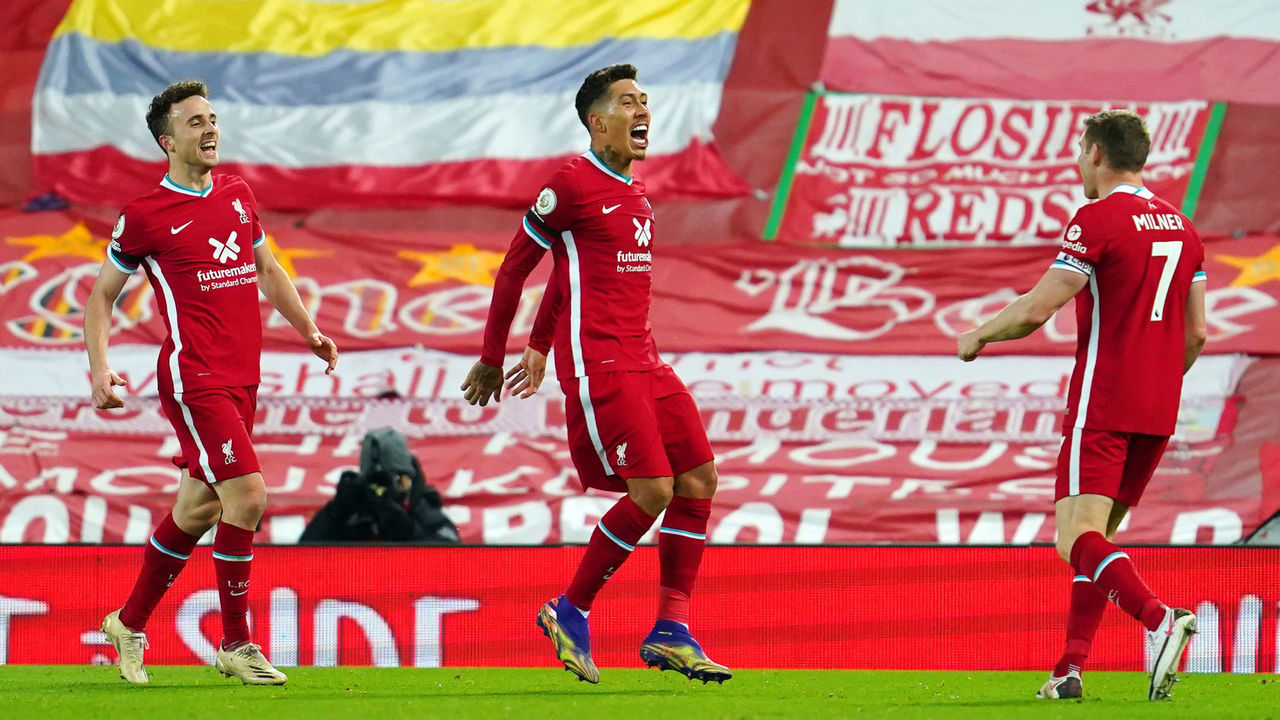 LIVERPOOL, ENGLAND - NOVEMBER 22: Roberto Firmino of Liverpool (C) celebrates with teammates Diogo Jota (L) and James Milner (R) after scoring their team's third goal during the Premier League match between Liverpool and Leicester City at Anfield on November 22, 2020 in Liverpool, England. Sporting stadiums around the UK remain under strict restrictions due to the Coronavirus Pandemic as Government social distancing laws prohibit fans inside venues resulting in games being played behind closed doors.