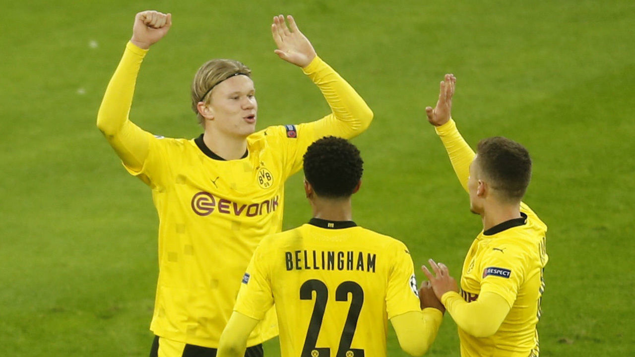 Dortmund's Norwegian forward Erling Braut Haaland (L) celebrates scoring the 3-0 goal with his team-mates during the UEFA Champions League group F football match BVB Borussia Dortmund v Club Brugge in Dortmund, western Germany, on November 24, 2020.