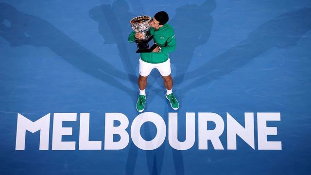 Serbia's Novak Djokovic kisses the Norman Brooks Challenge Cup trophy after winning against Austria's Dominic Thiem in their men's singles final match on day fourteen of the Australian Open tennis tournament in Melbourne on February 3, 2020.