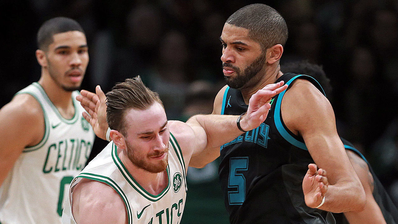 BOSTON, MA. - JANUARY 30: Gordon Hayward #20 pushes past Nicolas Batum #5 of the Charlotte Hornets as Jayson Tatum #0 of the Boston Celtics looks on during the first half of the NBA game at the TD Garden on January 30, 2019 in Boston, Massachusetts. (Staff Photo By Matt Stone/MediaNews Group/Boston Herald)