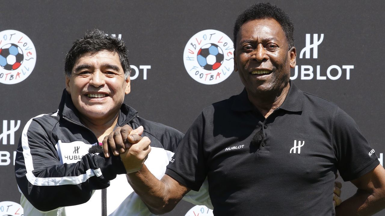 Former Argentinian football international Diego Maradona (L) and former Brazilian footballer Pele pose after a football match organised by Swiss luxury watchmaker Hublot at the Jardin du Palais Royal in Paris on June 9, 2016, on the eve of the Euro 2016 European football championships.