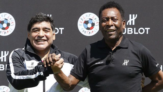 Former Argentinian football international Diego Maradona (L) and former Brazilian footballer Pele pose after a football match organised by Swiss luxury watchmaker Hublot at the Jardin du Palais Royal in Paris on June 9, 2016, on the eve of the Euro 2016 European football championships.
