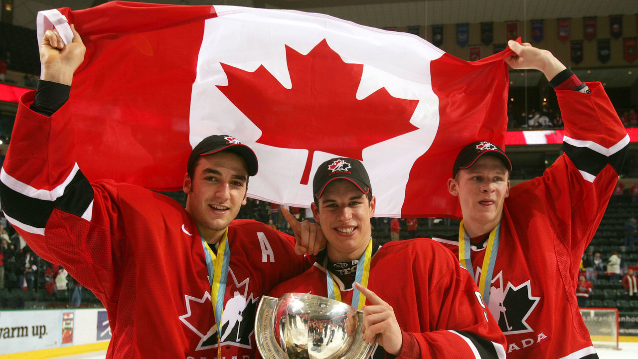 GRAND FORKS, ND - JANUARY 4: Corey Perry #24, Sidney Crosby #9 and Patrice Begeron #37 hold the World Junior Championship trophy after Canada won the gold medal game 6-1 over Russia at the World Junior Hockey Championships on January 4, 2005 at the Ralph Englestad Arena in Grand Forks, North Dakota.