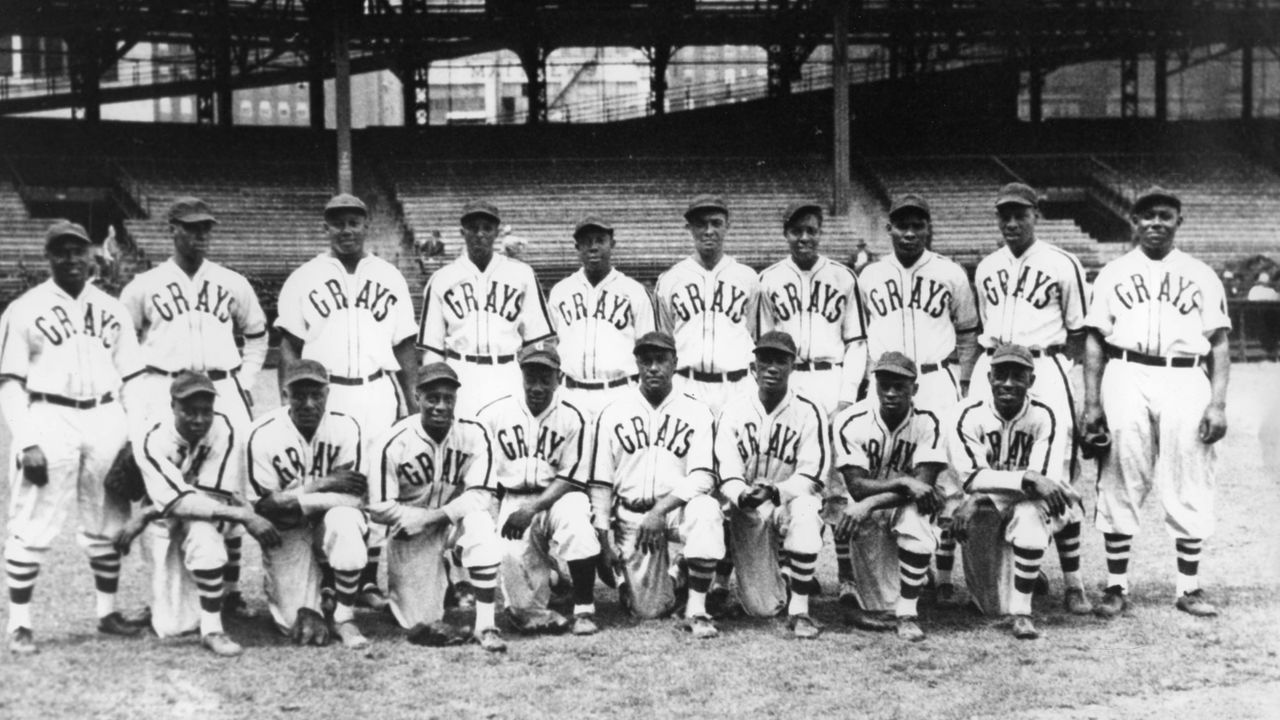 PITTSBURGH - 1942. The Homestead Grays Negro League baseball club pose for a team shot in their home park, Forbes Field in Pittsburgh, in 1942. Hall of Fame members on the club include Josh Gibson, standing, third from left and Buck Leonard, standing, far right,