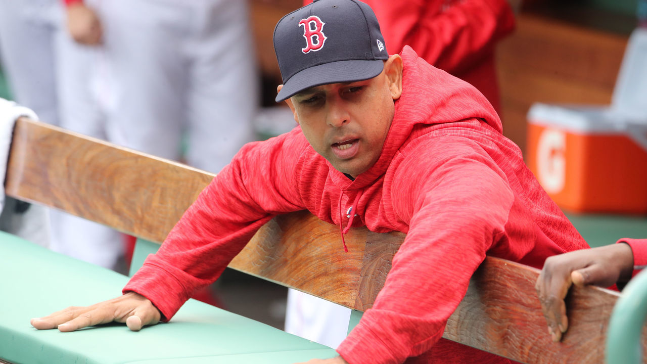 BOSTON - APRIL 29: Boston Red Sox manager Alex Cora checks the dampness of the bench before the start of the game. The Boston Red Sox host the Tampa Bay Rays in a regular season MLB baseball game at Fenway Park in Boston on April 29, 2018.