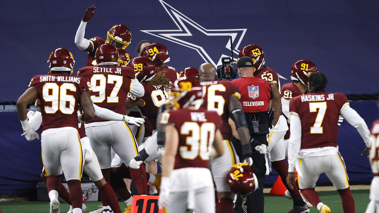 ARLINGTON, TEXAS - NOVEMBER 26: Montez Sweat #90 of the Washington Football Team celebrates with his teammates after an interception for a touchdown during the fourth quarter of a game against the Dallas Cowboys at AT&T Stadium on November 26, 2020 in Arlington, Texas.