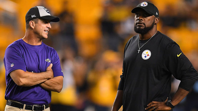 PITTSBURGH, PA - SEPTEMBER 30: head coach Mike Tomlin of the Pittsburgh Steelers talks with head coach John Harbaugh of the Baltimore Ravens during warmups before the game at Heinz Field on September 30, 2018 in Pittsburgh, Pennsylvania.