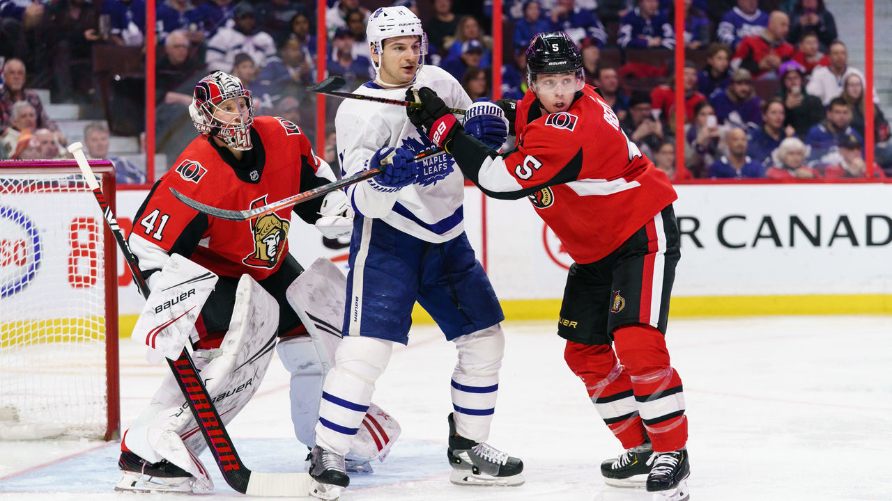 OTTAWA, ON - FEBRUARY 15: Marcus Hogberg #35 and Mike Reilly #5 of the Ottawa Senators defend against Zach Hyman #11 of the Toronto Maple Leafs at Canadian Tire Centre on February 15, 2020 in Ottawa, Ontario, Canada.