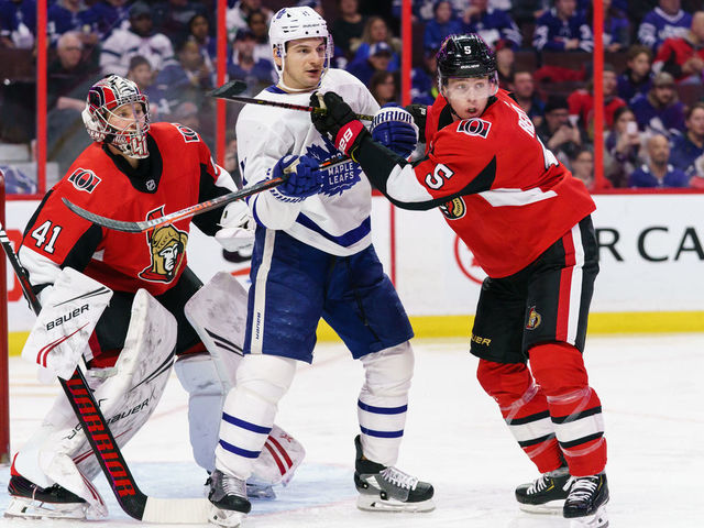OTTAWA, ON - FEBRUARY 15: Marcus Hogberg #35 and Mike Reilly #5 of the Ottawa Senators defend against Zach Hyman #11 of the Toronto Maple Leafs at Canadian Tire Centre on February 15, 2020 in Ottawa, Ontario, Canada.