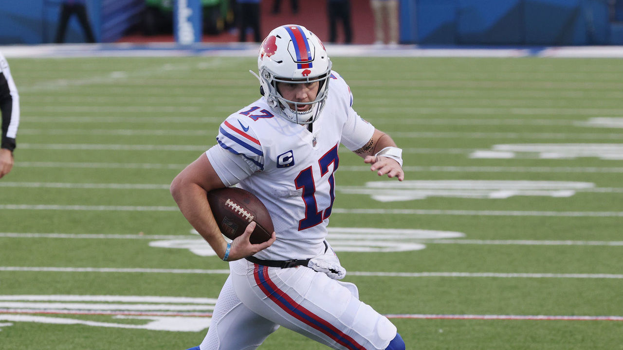 ORCHARD PARK, NEW YORK - NOVEMBER 29: Josh Allen #17 of the Buffalo Bills rolls out against Michael Davis #43 of the Los Angeles Chargers during the third quarter at Bills Stadium on November 29, 2020 in Orchard Park, New York.